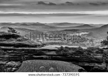 Black and White picture of the Prebischtor which is a narrow rock formation located in the Bohemian Switzerland in the Czech Republic. Picture taken on a stormy golden october day