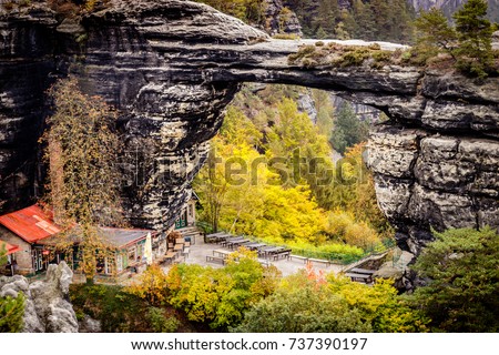 The Prebischtor is a narrow rock formation located in the Bohemian Switzerland in the Czech Republic. Picture taken on a stormy golden october day