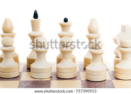 ordinary simple wooden chess, lying on a wooden chessboard with dark and light squares. photo close-up on a light background, not isolated
