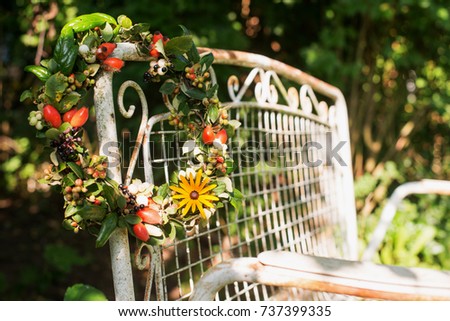 Autumn wreath on a old garden bench