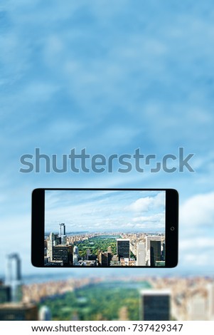 City on smartphone screen. Creative image 
