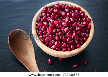 fresh juicy pomegranate diet fruit is a natural antioxidant on black background