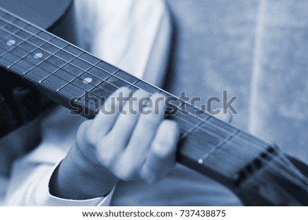 teen boy play the guitar music notes