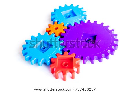 colorful gears for ideal team work technology white table background top view