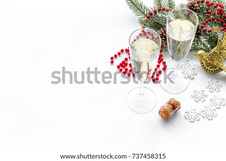 christmas design with decoration, spruce branch, champagne in glasses on white background copyspace