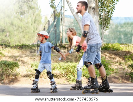 Family rollerskating in park