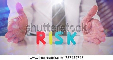 Mid section of businessman with colorful risk text against black background