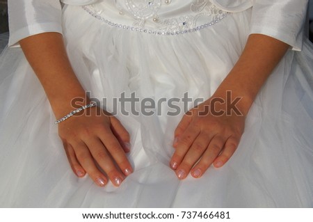 Cute little bridesmaid in white dress with hands on her belly Royalty-Free Stock Photo #737466481