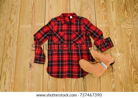 mens cotton plaid shirts- and shoes on wooden background