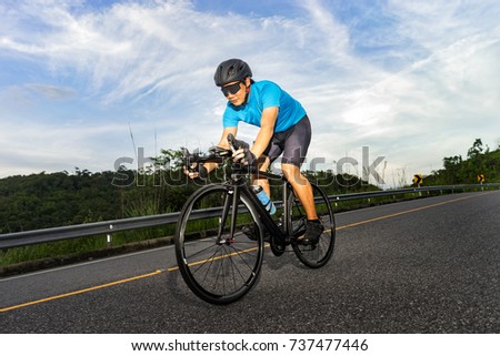 Cycling competition,cyclist athletes riding a race at high speed on mountain road, Sportsmen bikes in the morning,side view,vintage color,selective focus, sports concept,copy space