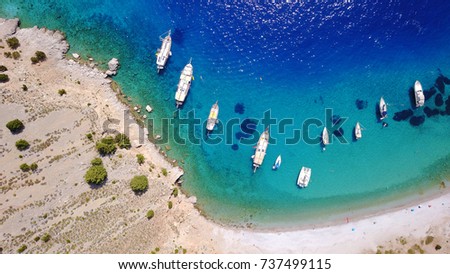 Aerial bird's eye view photo taken by drone of tropical rocky seascape with yachts docked and turquoise - sapphire clear waters