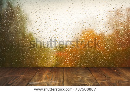 Table on rainy window background Royalty-Free Stock Photo #737508889