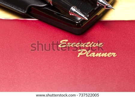 close up view on the executive planner with harddisk and pen in landscape orientation