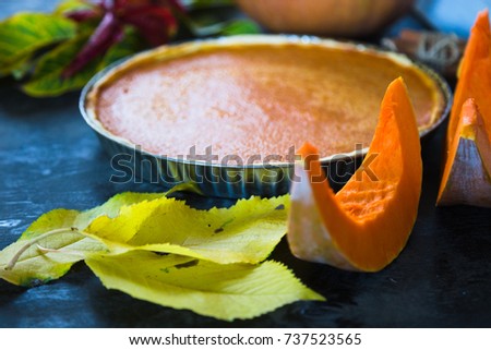 Pumpkin pie on black wooden desk. Homemade pie. Thanksgiving dinner. Autumn