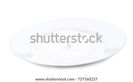 Plate with milk and amazing milk splassh. Horizontal close-up image, isolated over white background