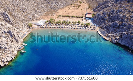 Aerial bird's eye view photo taken by drone of famous tropical rocky beach of Agios Nikolaos with clear turquoise waters, Symi island, Dodecanese, Greece
