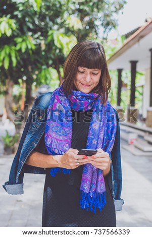Fashionable young woman with cashmere scarf stand outdoor. Bali island.