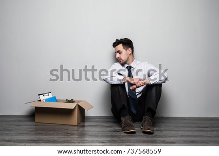 Fired frustrated man in suit sitting near office. Royalty-Free Stock Photo #737568559