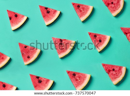 Colorful fruit pattern of fresh watermelon slices on blue background. From top view Royalty-Free Stock Photo #737570047