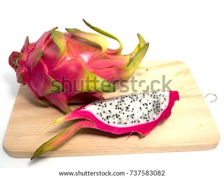 Dragon fruit on a cutting board on a white background.