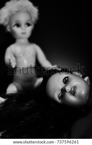 two creepy doll looking in selective focus and high contrast