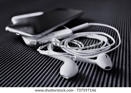 Black and white phones and white earphones 