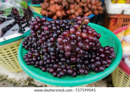 Grape market concept. Organic grape on basket in street market. grape is a fruit botanically a berry deciduous vine. Who eat fresh table grape or make wine jam juice and seed extract vinegar seed oil.