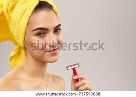 razor in the hand of a young woman, shower, beauty                               
