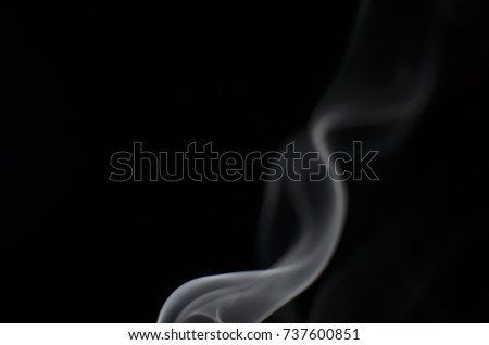 Light shine to smoke on black background, low key image.