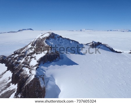 Mountain surrounded by glacier in Antarctica. Royalty-Free Stock Photo #737605324