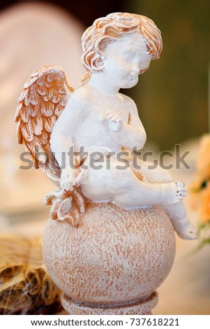 figurine angel white standing on the surface on occasion
