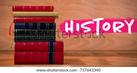 History text against white background against books stack on table