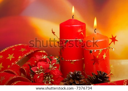 Christmas decoration with balls and candles, over colour background. Shallow DOF