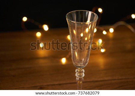 garland, empty glass on a wooden table, holiday, new year                               