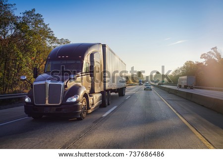 Truck on road at sunrise Royalty-Free Stock Photo #737686486