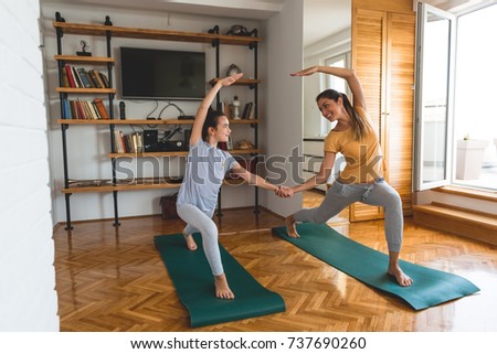 Mother and daughter exercising together 