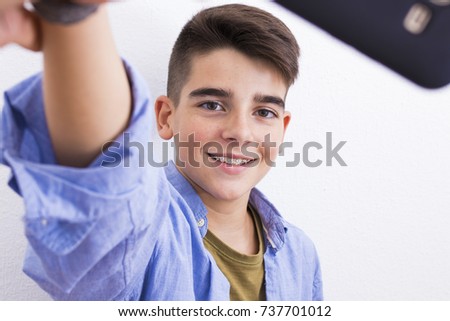 young teenager taking pictures with the phone
