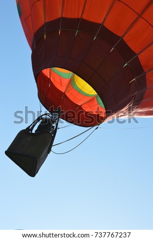 basket of a hot air red balloon lifting in the blue sky. Pattern texture photography