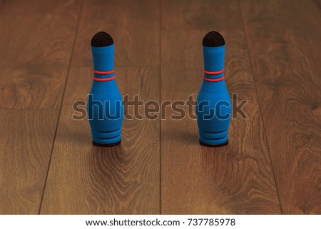 two skittles  from toy bowling on a wooden background
children's game