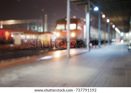 Background with red blurry train in railway station