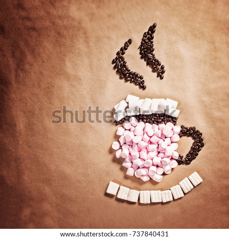 Mug cup of hot coffee cocoa from pink marshmallows and grain coffee on old paper background