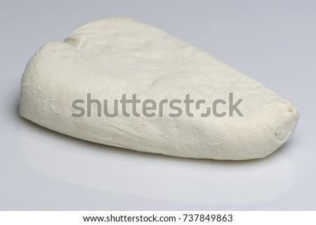 Homemade white cheese on white background. Close up, horizontal image