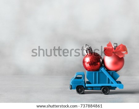 Christmas decoration. Truck car carries christmasballs for Christmas trees.