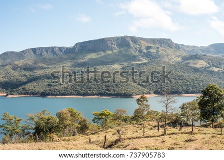 Mountain near the lake background of nature beautiful water and blue sky in minas gerl brazil serrado brazilian furnas rio grande