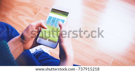 Digital 3D image of online education interface on screen against cropped image of woman sitting on floor while using her phone