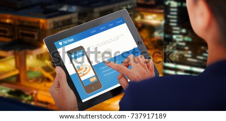 Businesswoman working on digital 3D tablet over white background against illuminated road in city at night