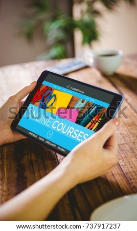 Computer generated 3D image of online education interface on screen against woman using her tablet pc