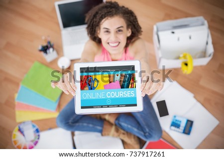 Computer generated 3D image of online education interface on screen against young creative businesswoman showing her tablet