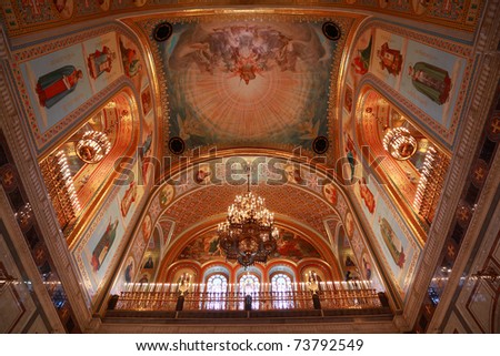 Pictured ceiling with lusters adorned by candles inside Cathedral of Christ the Saviour in Moscow, Russia