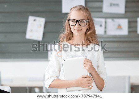 A little employee in glasses is just standing looking